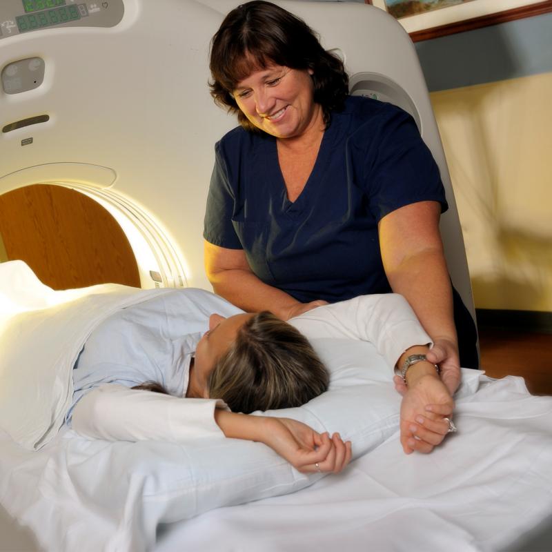 Technician with patient getting a CT scan.