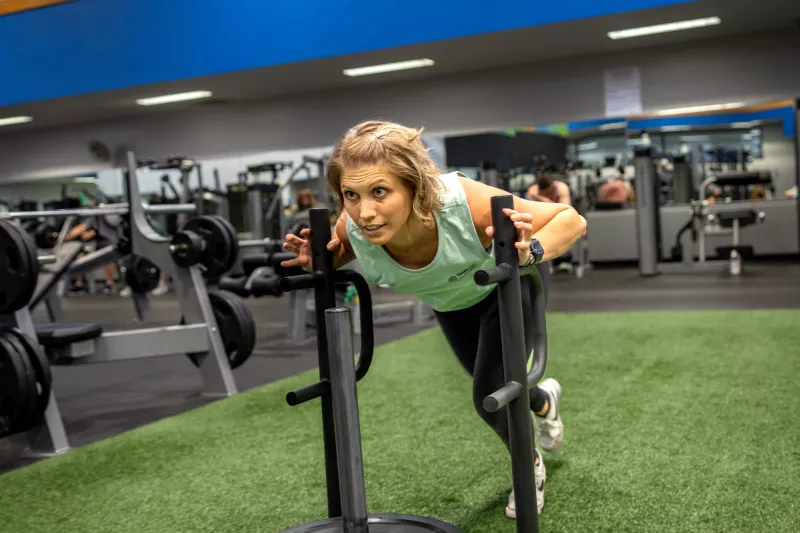 THH Fitness Center personal trainer demonstrating how to use the sled