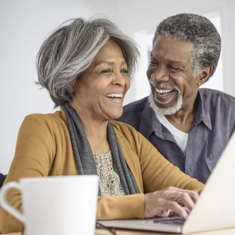 A mature couple using a computer.