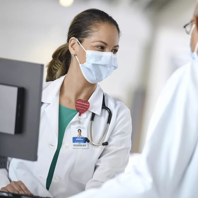 An AdventHealth team member talking with a patient. 